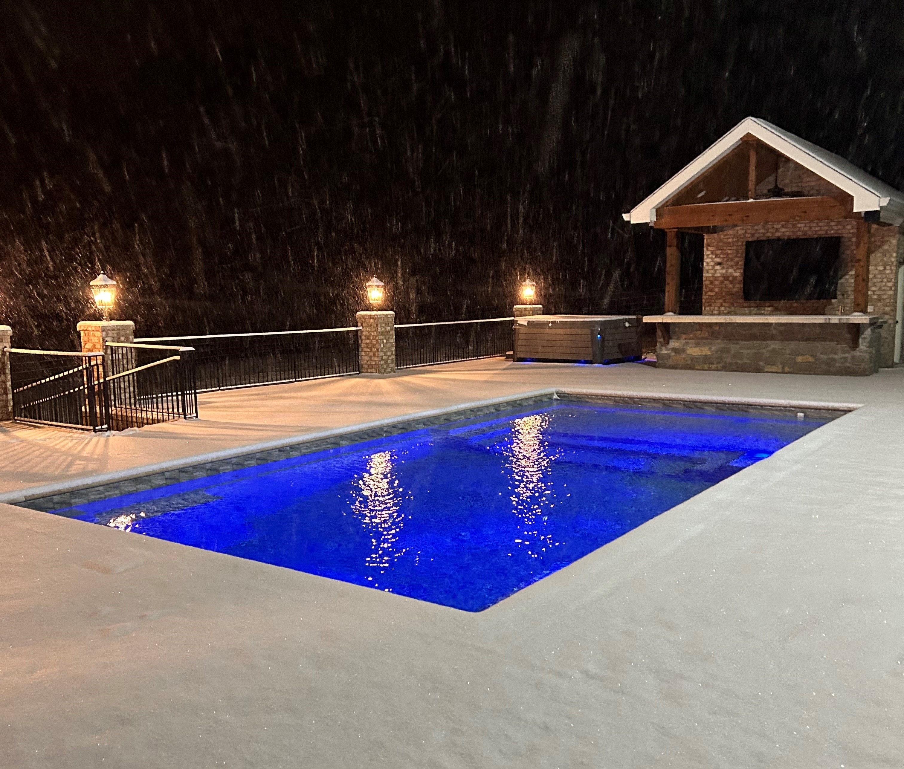 Illuminated backyard pool at night